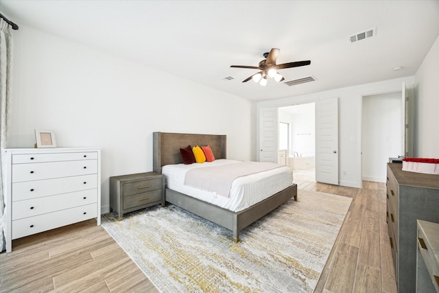 bedroom with ensuite bath and ceiling fan