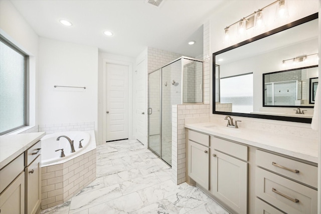 bathroom featuring vanity and separate shower and tub