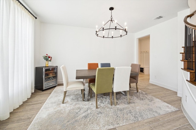 dining room featuring light hardwood / wood-style floors and a chandelier