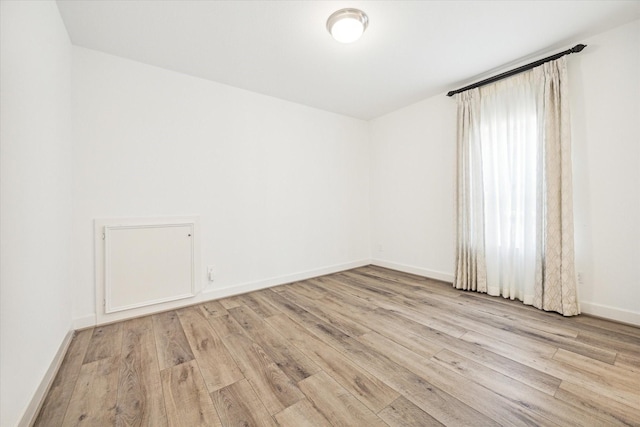 unfurnished room featuring light hardwood / wood-style floors