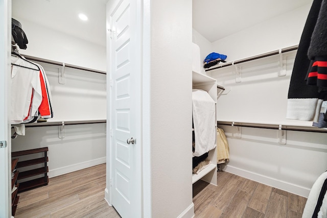 walk in closet with hardwood / wood-style floors