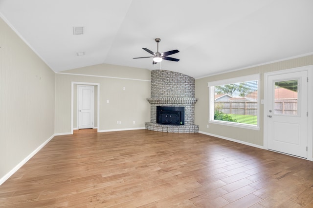 unfurnished living room featuring lofted ceiling, ceiling fan, light wood-type flooring, and a fireplace