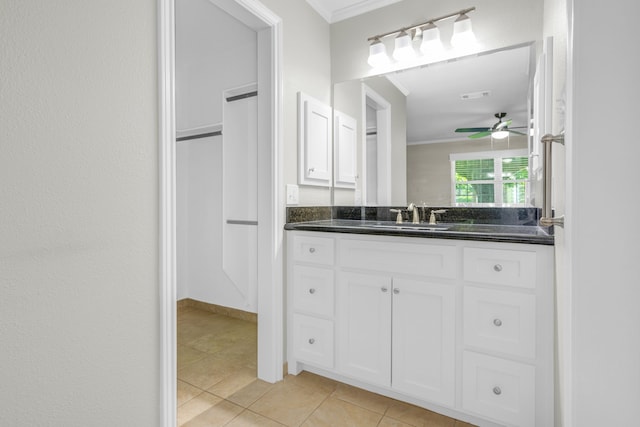 bathroom with vanity, ceiling fan, ornamental molding, and tile patterned floors