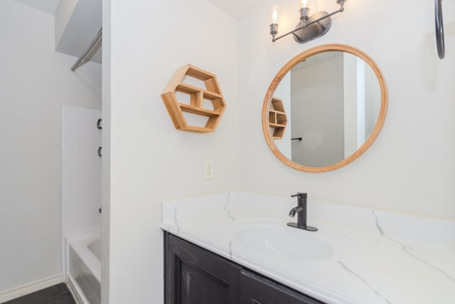 bathroom with tiled shower / bath combo and vanity