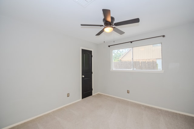 empty room featuring light carpet and ceiling fan