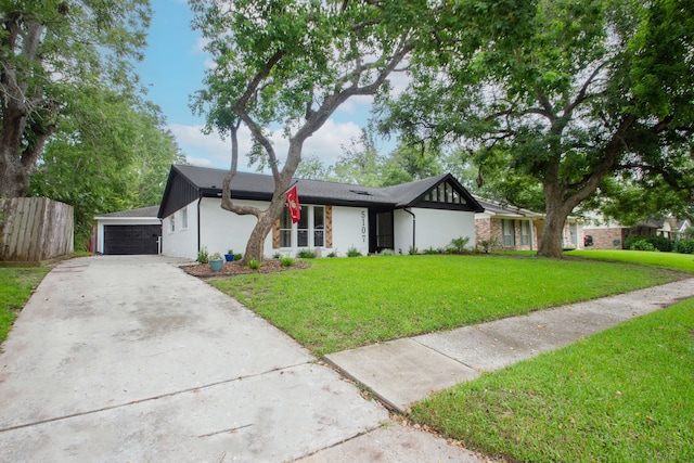 single story home with a garage and a front lawn