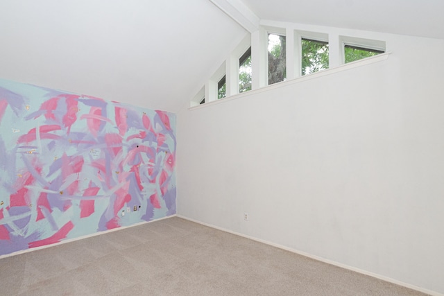 interior space featuring carpet and vaulted ceiling with beams