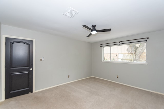 carpeted empty room featuring ceiling fan