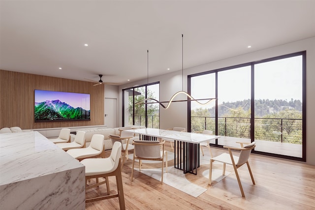 home theater with light wood finished floors, a ceiling fan, and recessed lighting
