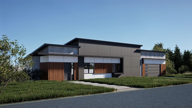 view of front of home with a front lawn and a garage