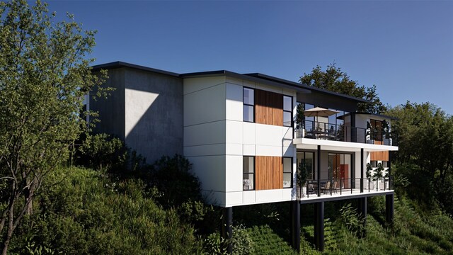 back of house featuring a balcony