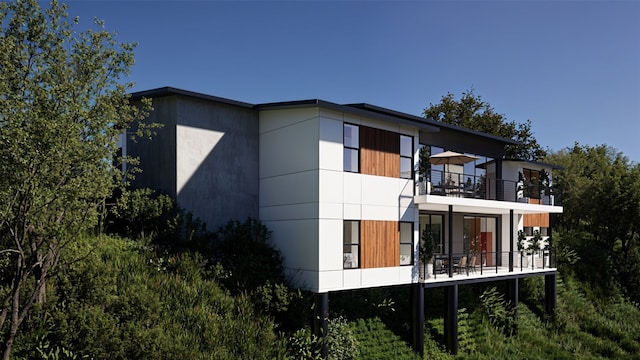 rear view of property featuring a balcony