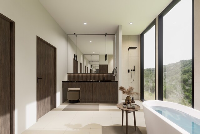 bathroom featuring tile patterned flooring, vanity, and shower with separate bathtub