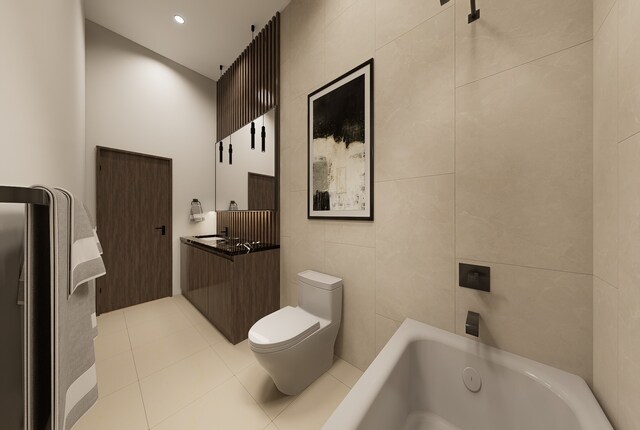 bathroom with tile patterned floors, a bathtub, toilet, and tile walls