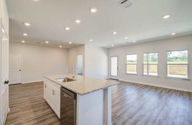 kitchen featuring wood-type flooring, a center island with sink, sink, dishwasher, and white cabinets