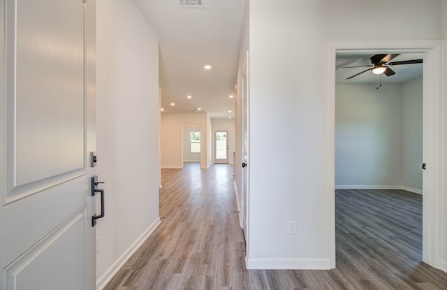 corridor with light hardwood / wood-style flooring