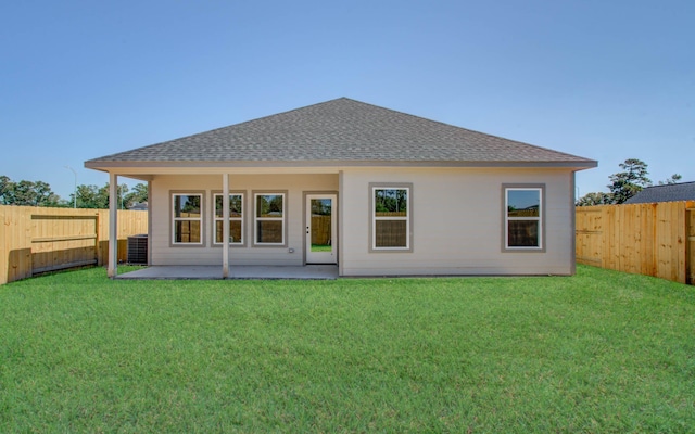 rear view of property featuring a patio, central AC unit, and a lawn