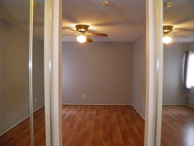 interior space with ceiling fan and hardwood / wood-style floors