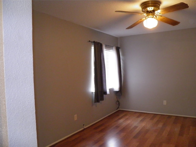 spare room with ceiling fan and hardwood / wood-style flooring