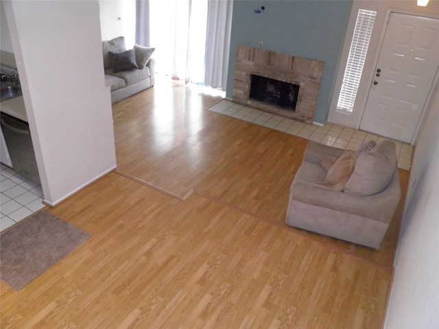 living room featuring a wealth of natural light, light hardwood / wood-style flooring, and a fireplace