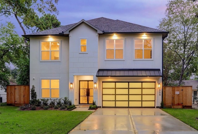 view of front of home with a lawn and a garage