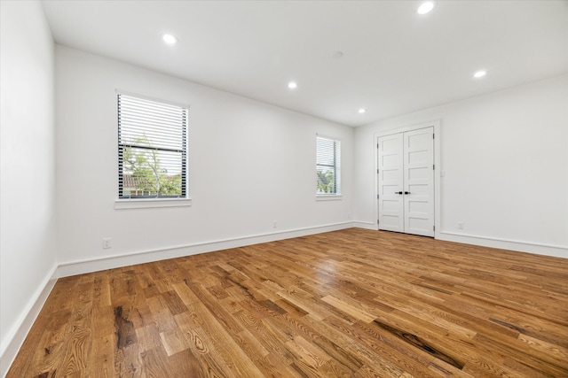 empty room with light hardwood / wood-style flooring