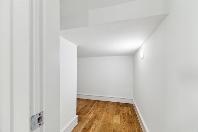 corridor with wood-type flooring