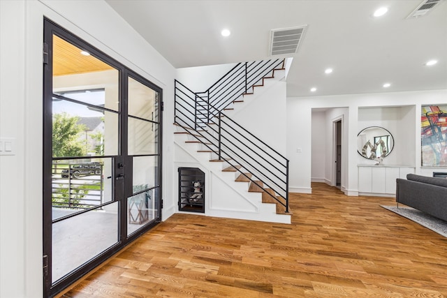 foyer entrance with french doors and light wood-type flooring