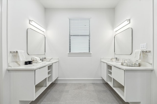 bathroom featuring concrete floors and dual bowl vanity