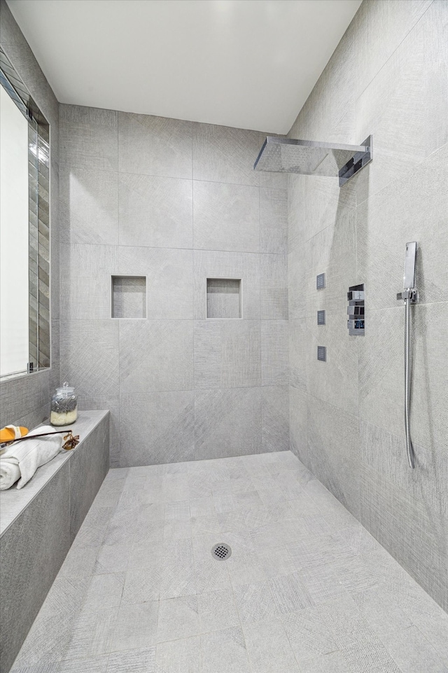 bathroom with a tile shower