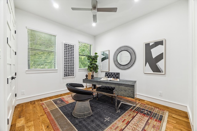 office space featuring ceiling fan and light hardwood / wood-style floors