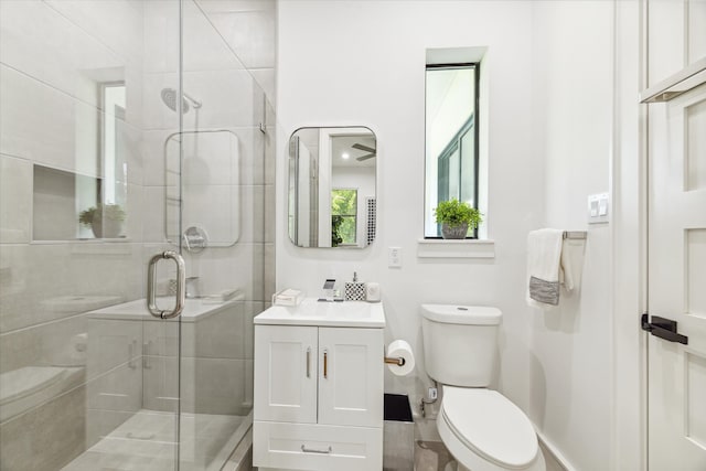 bathroom with walk in shower, toilet, and vanity