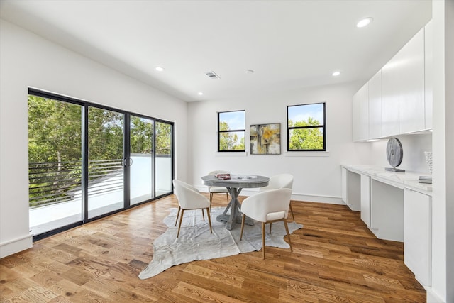 dining area featuring hardwood / wood-style flooring and a healthy amount of sunlight