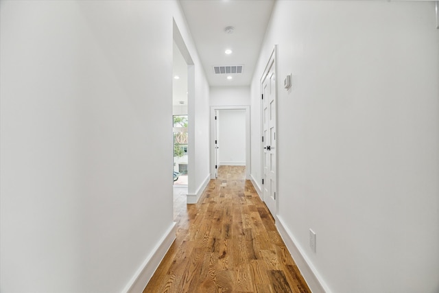 hallway with hardwood / wood-style floors