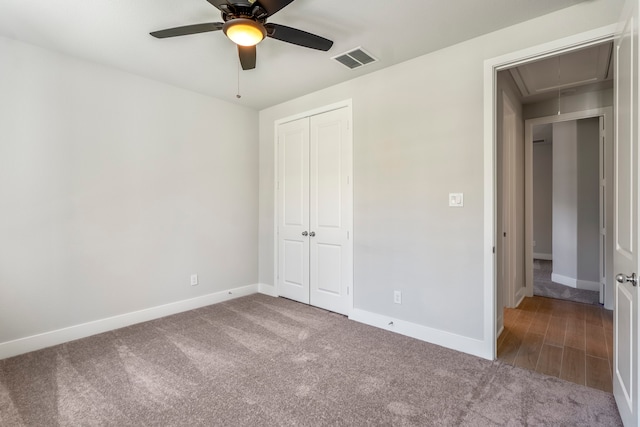 unfurnished bedroom featuring a closet, carpet floors, and ceiling fan