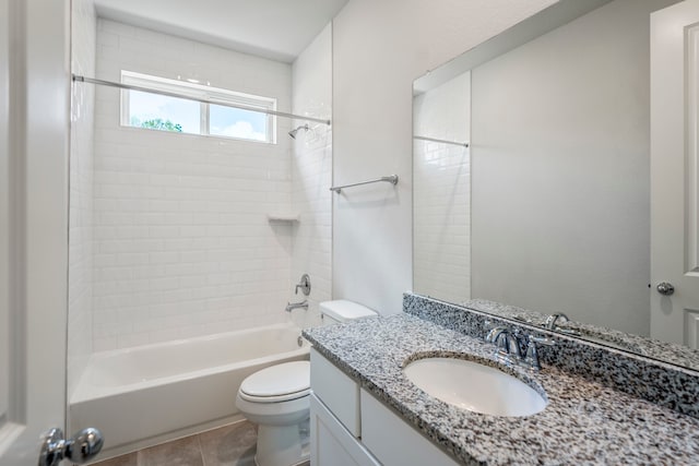 full bathroom featuring tile patterned floors, tiled shower / bath, vanity, and toilet