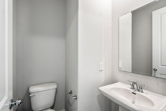 bathroom with toilet and sink