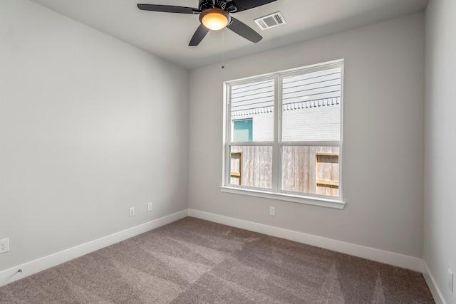 carpeted empty room featuring ceiling fan