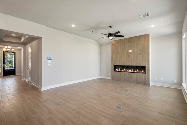 unfurnished living room with a fireplace, light wood-type flooring, and ceiling fan