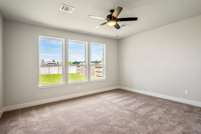 spare room featuring carpet flooring and ceiling fan