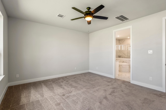 unfurnished bedroom with ensuite bathroom, ceiling fan, and carpet flooring