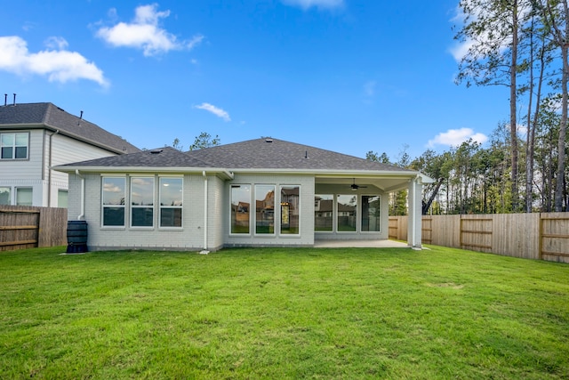 back of house featuring a patio, ceiling fan, and a lawn