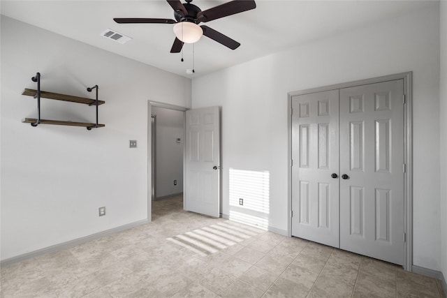 unfurnished bedroom featuring a closet, visible vents, ceiling fan, and baseboards