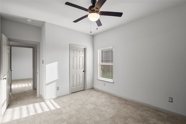 unfurnished bedroom with light tile patterned floors and ceiling fan