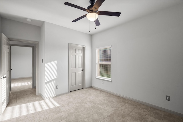 unfurnished bedroom with baseboards and a ceiling fan