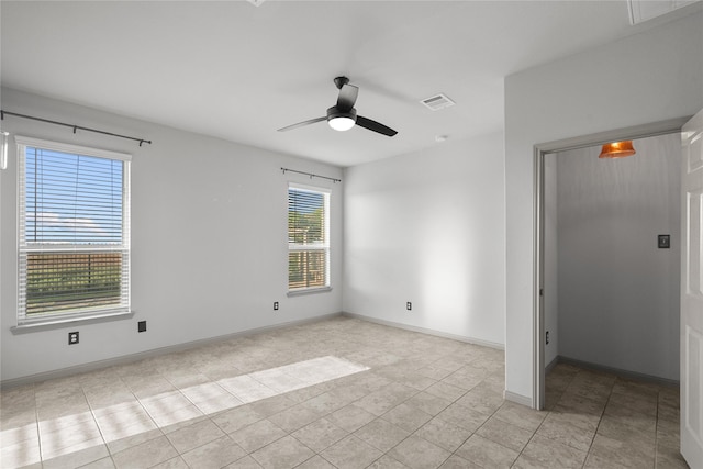 unfurnished bedroom with ceiling fan, light tile patterned floors, visible vents, and baseboards