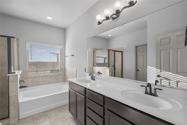 bathroom with tile patterned floors, plus walk in shower, and dual bowl vanity