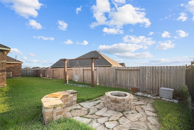 view of yard with a patio and an outdoor fire pit