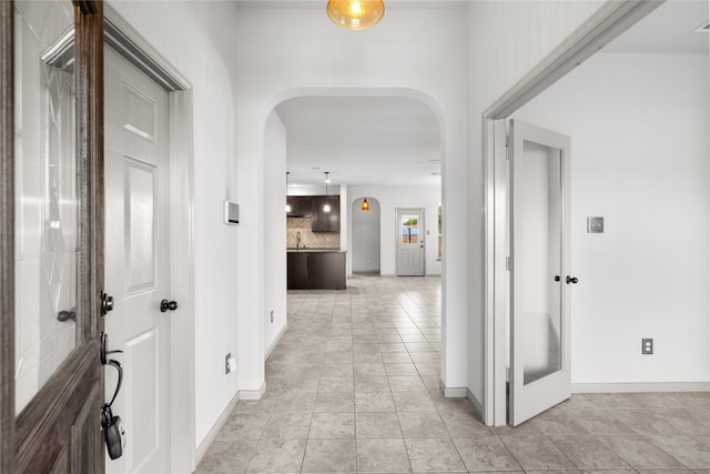 corridor with light tile patterned floors