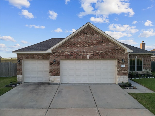 single story home with a garage, stone siding, roof with shingles, and brick siding